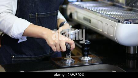 Asian women Barista smiling and using coffee machine in coffee shop counter - Working woman small business owner food and drink cafe concept Stock Photo
