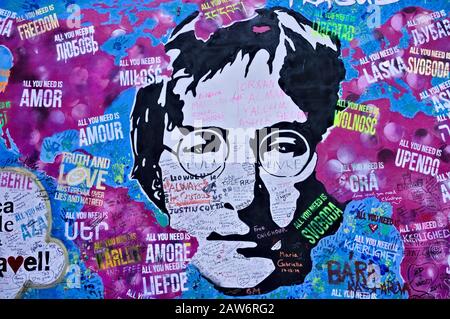 Prague, Czech Republic - 30 December 2019: the colored graffiti of 'The Lennon Wall' showing John Lennon face and peace and love messages Stock Photo