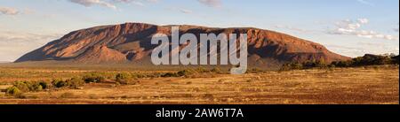 A horizontal panorama of Mount Augustus in the golden hour light in the Gascoyne region of Western Australia. Stock Photo