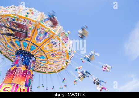 Chain carousel ride in an amusement parks carnivals or funfair, Munich, German Stock Photo