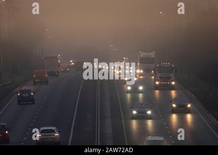 Flintshire, North Wales, 7th February 2020. UK Weather:  Severe overnight frost with temperatures below freezing in rural Flintshire and the prospect of Storm Ciara and snow in the coming days. A cold foggy start to the day with winds starting to pick up speed in Flintshire as these motorists discovered travellign along the A55 near Halkyn © DGDImages/AlamyLiveNews Stock Photo