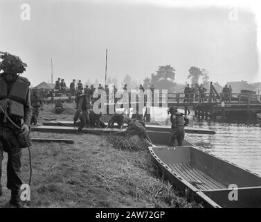 Queen Juliana and Prince Bernhard visited 4th Division of the Army. Soldiers with boats Date: September 27, 1961 Keywords: royal visits, military, army units Person Name: Juliana (queen Netherlands) Stock Photo