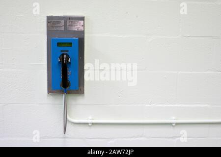 A telephone for newly-arrived prisoners at HMP Liverpool, also known as Walton Prison. The prison was given a scathing report in 2017 which pointed out various failings and problems. Present governor Pia Sinha was appointed in that year and in the next two years she turned the prison around with a programme of improvements and support for inmates and infrastructure. HMP Liverpool houses a maximum of 700 prisoners with an overall staff of around 250. Stock Photo