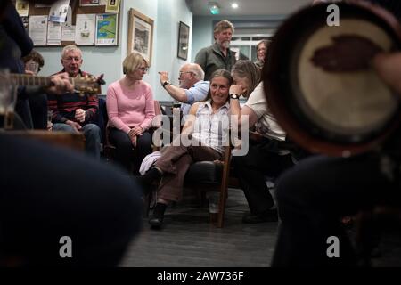 Local GP Dr Jan Brooks (second right) pictured during a music session at the Colonsay Hotel on the the Inner Hebridean island of Colonsay on Scotland's west coast.  The island is in the council area of Argyll and Bute and has an area of 4,074 hectares (15.7 sq mi). Aligned on a south-west to north-east axis, it measures 8 miles (13 km) in length and reaches 3 miles (4.8 km) at its widest point, in 2019 it had a permanent population of 136 adults and children. Stock Photo