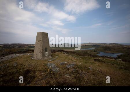 Looking across the Inner Hebridean island of Colonsay on Scotland's west coast from the highest point, Carnan Eoin. The island is in the council area of Argyll and Bute and has an area of 4,074 hectares (15.7 sq mi). Aligned on a south-west to north-east axis, it measures 8 miles (13 km) in length and reaches 3 miles (4.8 km) at its widest point, in 2019 it had a permanent population of 136 adults and children. Stock Photo