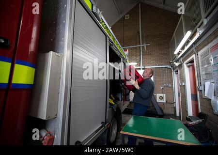 Volunteer fire fighter Les Robinson checking equipment during a training drill on the the Inner Hebridean island of Colonsay on Scotland's west coast.  The island is in the council area of Argyll and Bute and has an area of 4,074 hectares (15.7 sq mi). Aligned on a south-west to north-east axis, it measures 8 miles (13 km) in length and reaches 3 miles (4.8 km) at its widest point, in 2019 it had a permanent population of 136 adults and children. Stock Photo