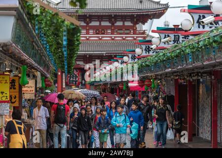 Tokyo, Japan - August 29, 2016: Japanese children and adults walking souvenir shops alley in Asakusa near Senso-ji landmark Stock Photo