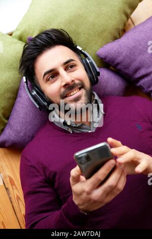 Man listing to music wearing headphones Stock Photo