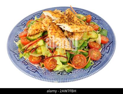 Fresh chicken salad on a blue decorated plate isolated on a white background Stock Photo