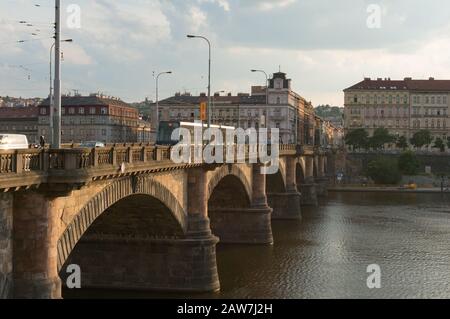 Prague, Czech Republic - May 22, 2018: Old bridge with tramway moving over Vltava river in Prague city center Stock Photo