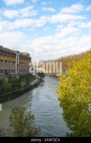 walking along Rome's Tiber river with view on Tiberina island Stock Photo