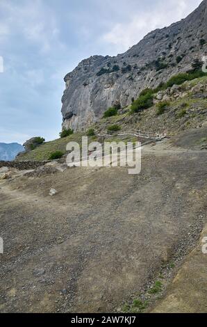 A tourist route along a trail in the mountains of the southern coast of Crimea, a beautiful view of the Black Sea and rocks. Golitsyna trail, Republic Stock Photo