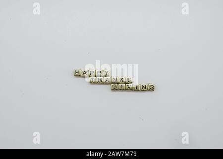 Happy Thanksgiving gold aphabet dice on a white background Stock Photo