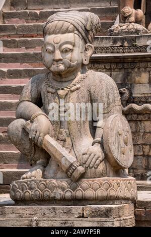 Staircase flanked by stone figures of the temple guardians at Nyatapola Temple in Bhaktapur, Kathmandu valley, Nepal Stock Photo