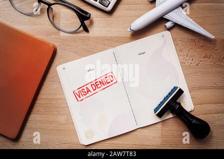 visa and passport with denied stamp on a document top view in immigration. travel immigration stamp and tourism concept Stock Photo