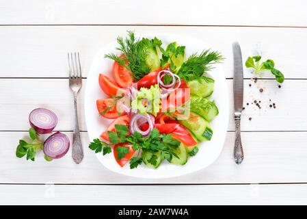 Fresh vegetables sliced in a plate. On the old background. free copying space. Stock Photo