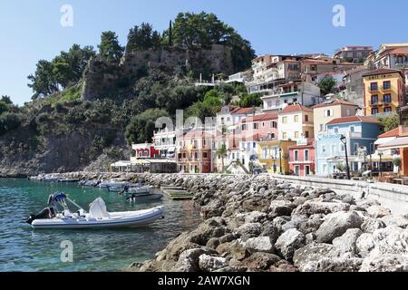 The Venetian Castle of Parga overlooking the colourful houses upon Parga Town's shoreline, viewed on a beautiful autumn day. Stock Photo