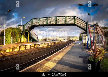 The station at Sandside near Kirkby-in-Furness under golden morning light with the snow capped Lakeland Fells in the background.  Fujifilm X-T3, Fujin Stock Photo