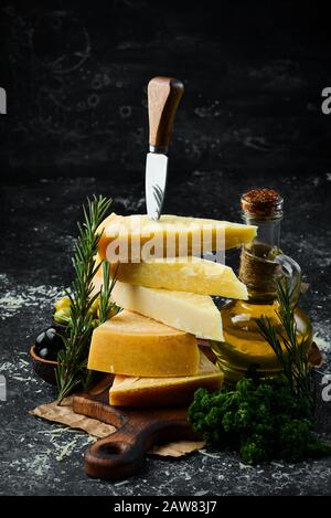 Piece of Parmesan cheese and cheese knife. On a stone background. Traditional Italian cheese. Top view. Free space for your text. Stock Photo