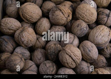 Walnuts background. Walnuts texture. Group walnuts on wooden background. Healthy organic food concept. Top view. Stock Photo