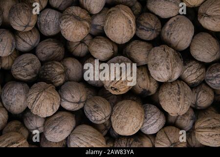Walnuts background. Walnuts texture. Group walnuts on wooden background. Healthy organic food concept. Top view. Stock Photo