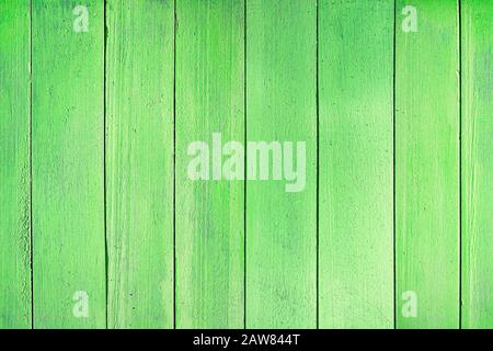 Rustic green wood background. Seamless horizontal texture of wooden planks placed vertically. The uniform color of the wooden fence. Stock Photo