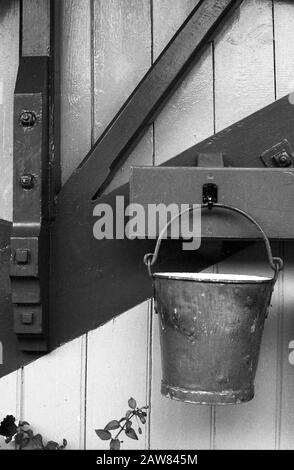 Old firebucket at Alton station, Mid-Hants Steam Railway (The Watercress Line), Hampshire, England, UK.  Black and white film photograph, circa 1996 Stock Photo