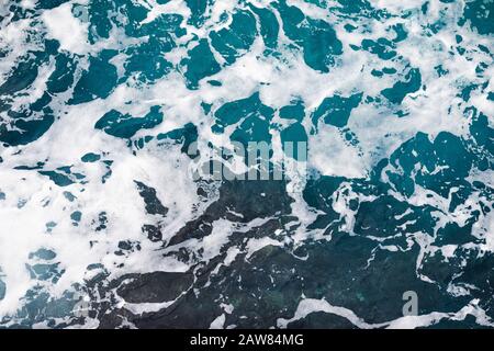 Ocean texture with white foam from the waves Stock Photo