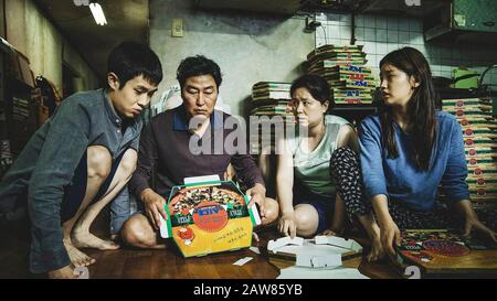 Parasite [Gisaengchung ] (2019) directed by Bong Joon Ho and starring Woo-sik Choi, Kang-ho Song, Hye-jin Jang and So-dam Park. The Kim family folds pizza boxes in their subbasement apartment. Stock Photo