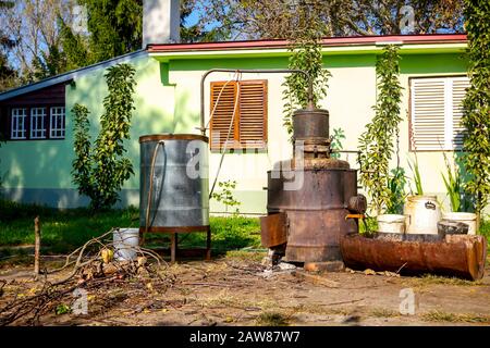 Domestic production with homemade distillery made of copper, making moonshine schnapps, alcoholic beverages such as brandy, vodka, cognac, whiskey, bo Stock Photo