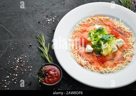 Salmon carpaccio with red caviar. Top view. Free space for your text. Stock Photo