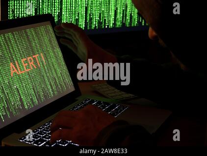 Hacker using computer in the dark Stock Photo