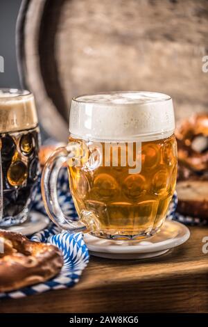 Oktoberfest beer with pretzel wooden barrel and blue tablecloth Stock Photo