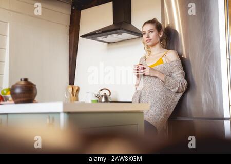 Attractive blonde woman being deep in thoughts Stock Photo