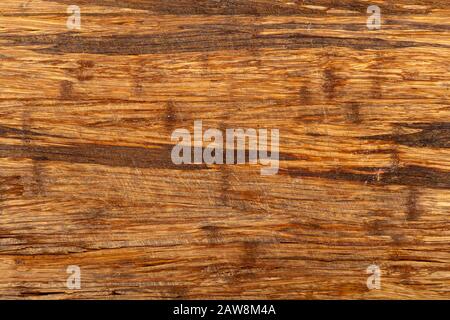 Old scratched wooden cutting board texture background. Stock Photo