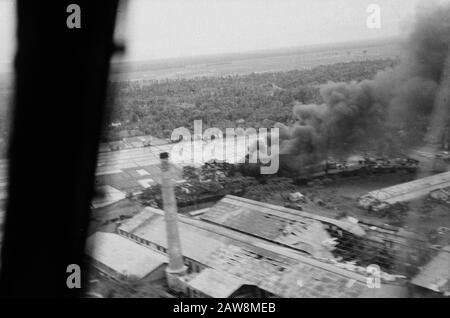 Food et al dropping infantry [2nd Police Action in December 1948]  [Luchtopname. Factory Complex with rice fields. Visible are vandalism. A building is on fire] Date: December 1948 Location: Indonesia Dutch East Indies