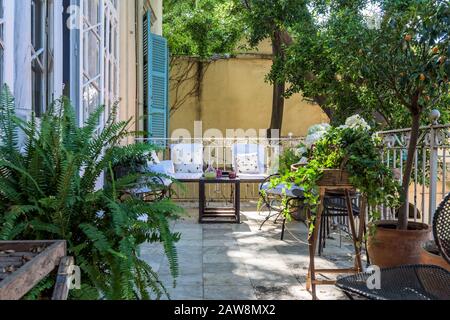 Chairs and potted plants on balcony Stock Photo