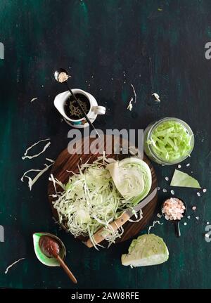 Finely shredded cabbage for kimchi or Sauerkraut with soy sauce, chili paste, sea salt, sesame seeds. Homemade, kitchen, organic, preserve, pickling. Stock Photo