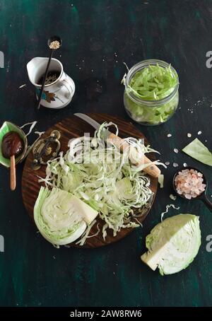 Finely shredded cabbage for kimchi or Sauerkraut with soy sauce, chili paste, sea salt, sesame seeds. Homemade, kitchen, organic, preserve, pickling. Stock Photo