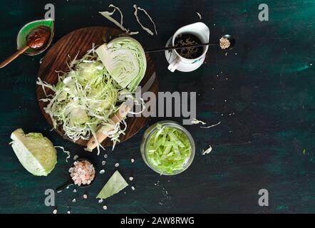 Finely shredded cabbage for kimchi or Sauerkraut with soy sauce, chili paste, sea salt, sesame seeds. Homemade, kitchen, organic, preserve, pickling. Stock Photo