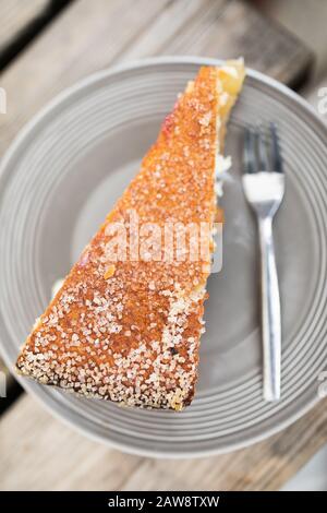 Top down view of an apple pie on a plate laying on a wooden table Stock Photo
