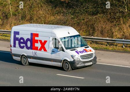 FEDEX express American multinational delivery services delivery truck Mercedes Benz Sprinter van on the M61, Manchester UK; Vehicular traffic, transport, motorway traffic. Stock Photo