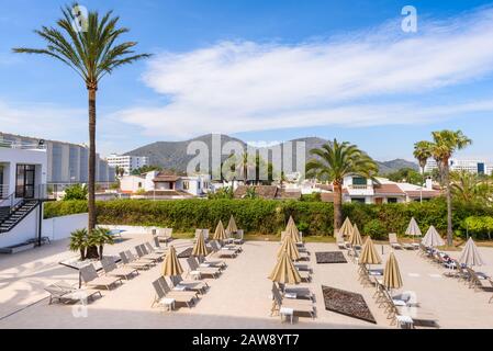 Mallorca, Spain - May 8, 2019: Pool area of the AluaSoul Alcudia Bay hotel. Hotel is a 4-star resort in Alcudia town on the island of Mallorca. Stock Photo