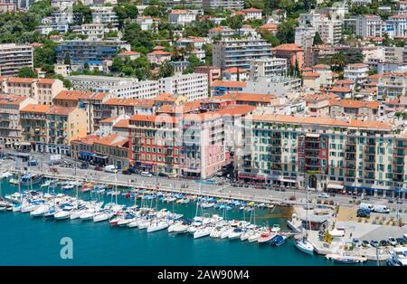 Nice, France - 15th may 2015: Boats docked in front of colourful  buildings of port of Nice in the south of France Stock Photo