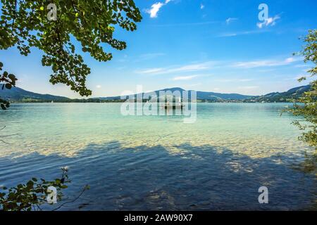 Steinbach am Attersee, Austria - June 22, 2014: View over the lake Attersee with fisherman with boat. Stock Photo