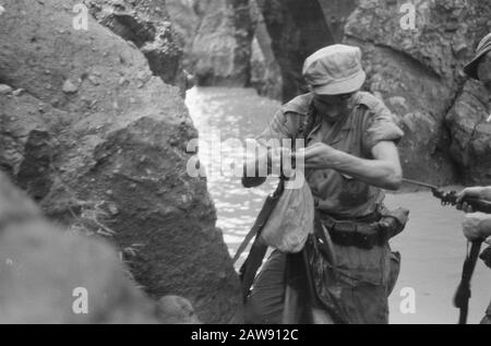 Action 4-4 Battalion Hunters in Magetan, East Java  Operation Clean Ship. Patrol passes through a watercourse Date: March 29, 1949 Location: Indonesia, Java, Dutch East Indies Stock Photo