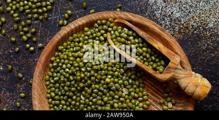Dried mung beans with a spoon on a dark background  top view Stock Photo