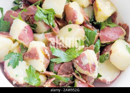 Healthful potato salad is made from red new potatoes and turkey bacon in a homemade vinaigrette dressing. Stock Photo
