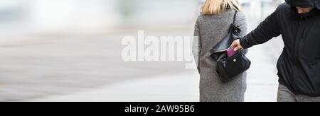 Close-up Of A Person Stealing Purse From Handbag Stock Photo
