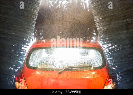 Automatic Car Wash With Water In Action Stock Photo